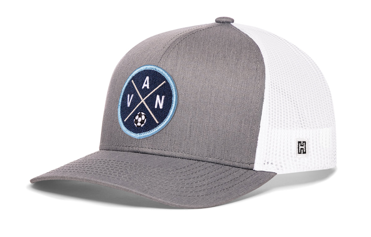 Vancouver Soccer Trucker Hat, gray-white snapback showing Haka brandmark on left side of cap.