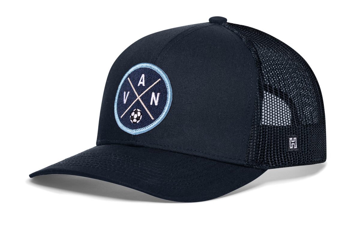 Vancouver Soccer Trucker Hat, navy snapback showing Haka brandmark on left side of cap.