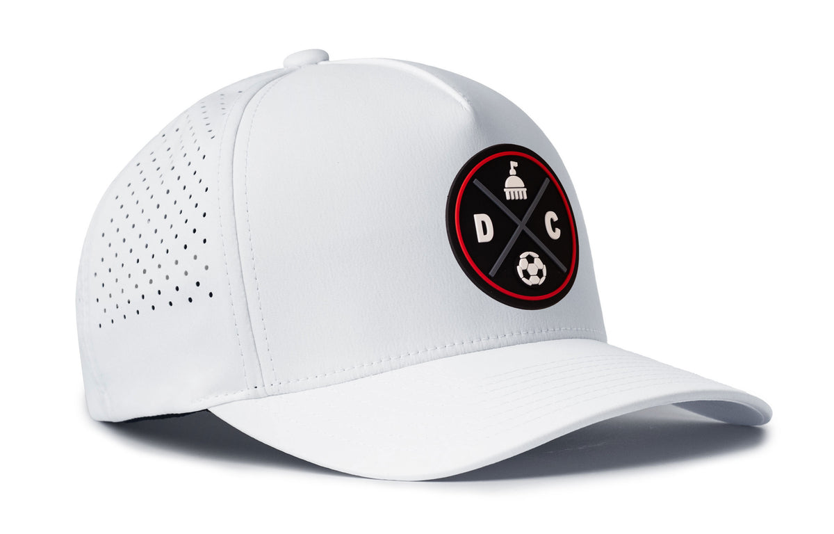 white performance 5-panel hat viewed from the right side, showcasing a bold black and red pvc patch prominently displayed on the front