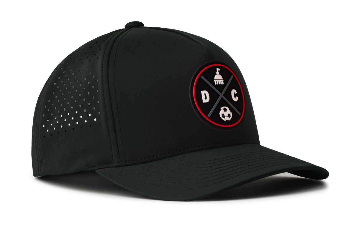 black performance 5-panel hat viewed from the right side, showcasing a bold black and red pvc patch prominently displayed on the front