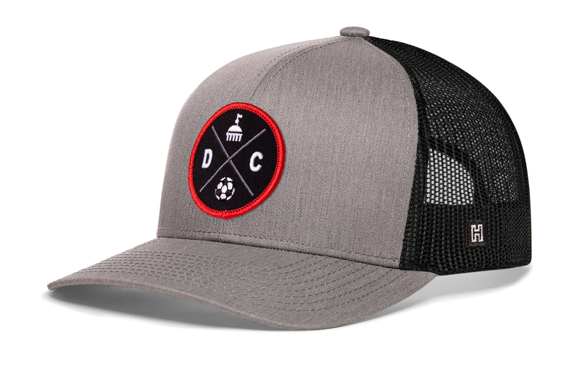 Washington DC Soccer Trucker Hat, gray-black snapback showing Haka brandmark on left side of cap.