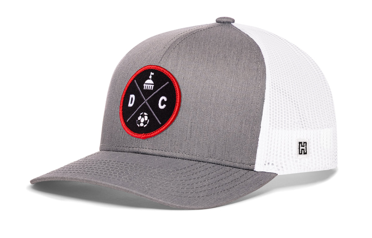 Washington DC Soccer Trucker Hat, gray-white snapback showing Haka brandmark on left side of cap.