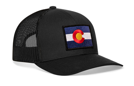 Black trucker hat viewed from the right side, showcasing a Colorado Flag Embroidered Rectangle Patch prominently displayed on the front