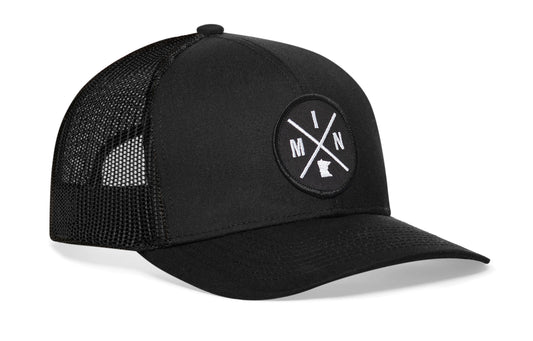 Black trucker hat viewed from the right side, showcasing a Minnesota MIN X Embroidered Circle Patch prominently displayed on the front