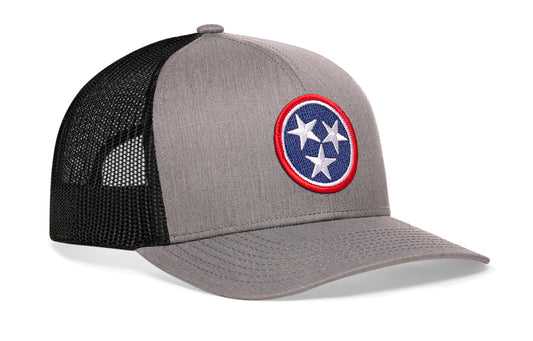 Gray-Black trucker hat viewed from the right side, showcasing a Tennessee Gray- TN Embroidered Flag Patch prominently displayed on the front