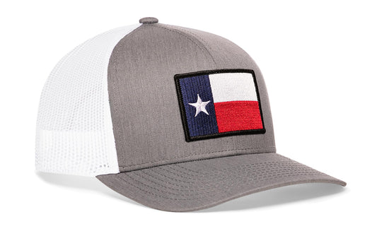 Gray-White trucker hat viewed from the right side, showcasing a Texas TX Embroidered Flag Patch prominently displayed on the front