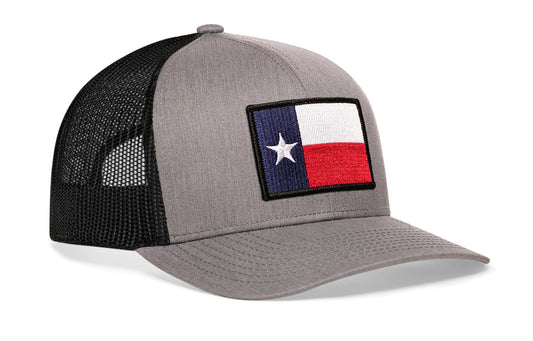 Gray-Black trucker hat viewed from the right side, showcasing a Texas Gray-Black TX Embroidered Flag Patch prominently displayed on the front