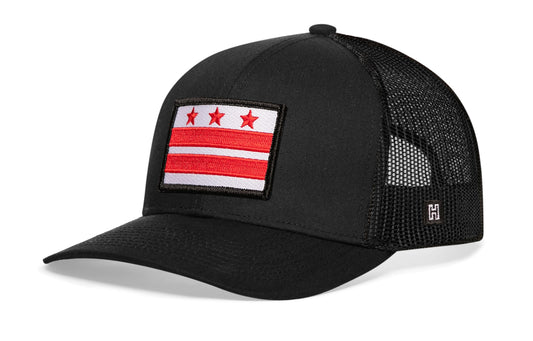 Washington DC Flag Trucker Hat, black snapback showing Haka brandmark on left side of cap.
